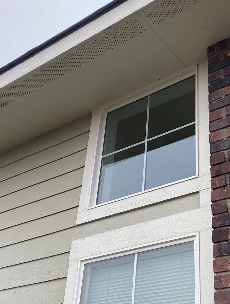 Upper-story window before and after hard water haze removal (after)